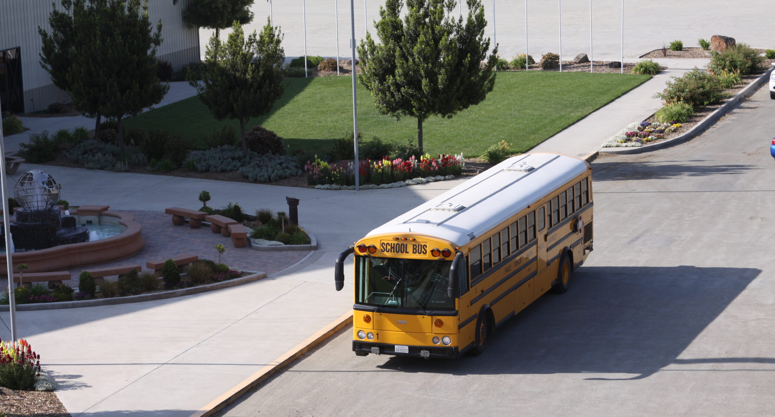 Yellow school bus parked in front of the Heritage Complex at the International Agri-Center